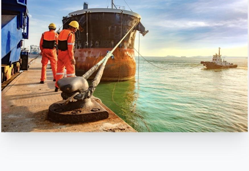 Dockworkers guiding a ship into port